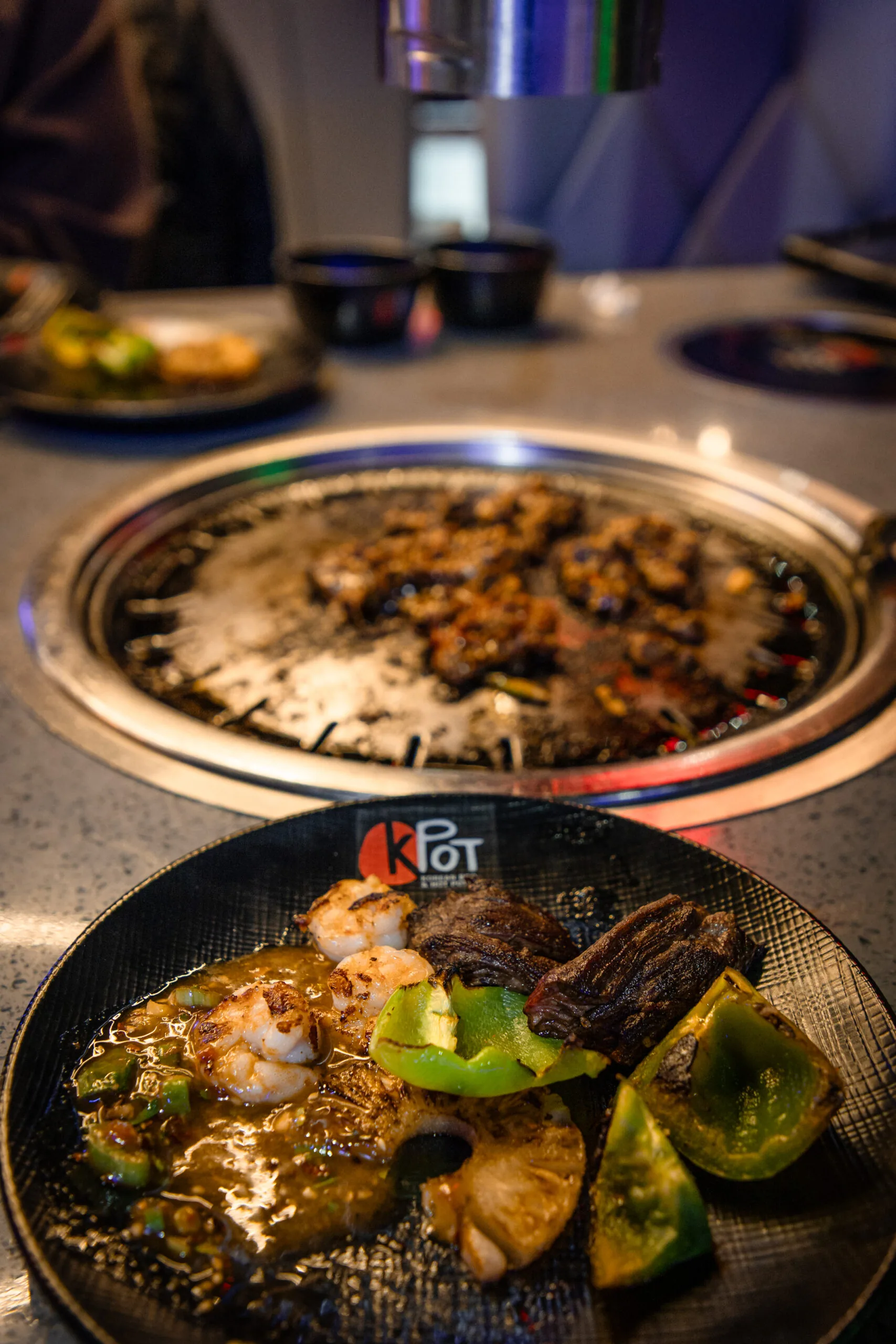 Plate of cooked food next to the grill at KPOT