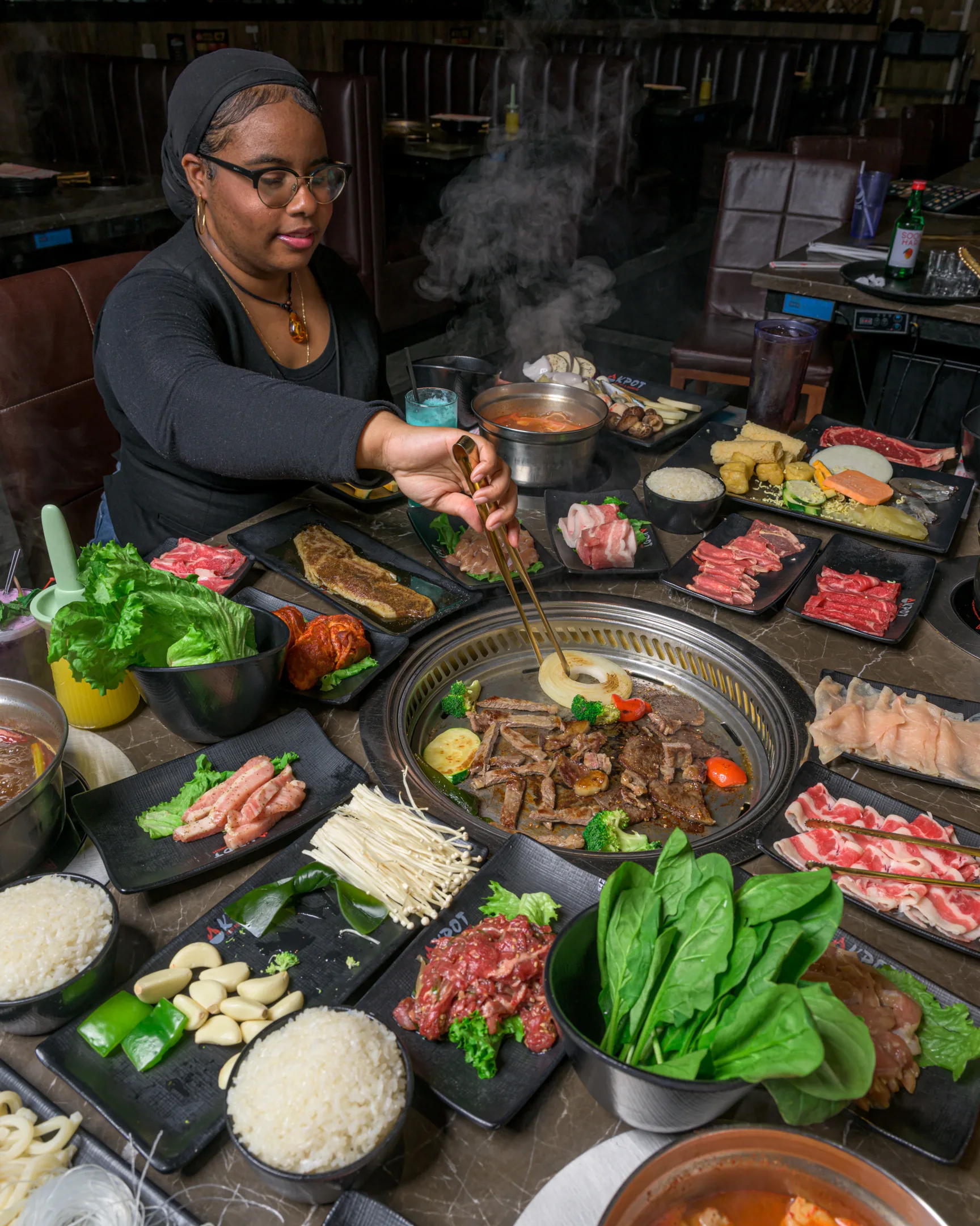 Person grilling meats at KPOT