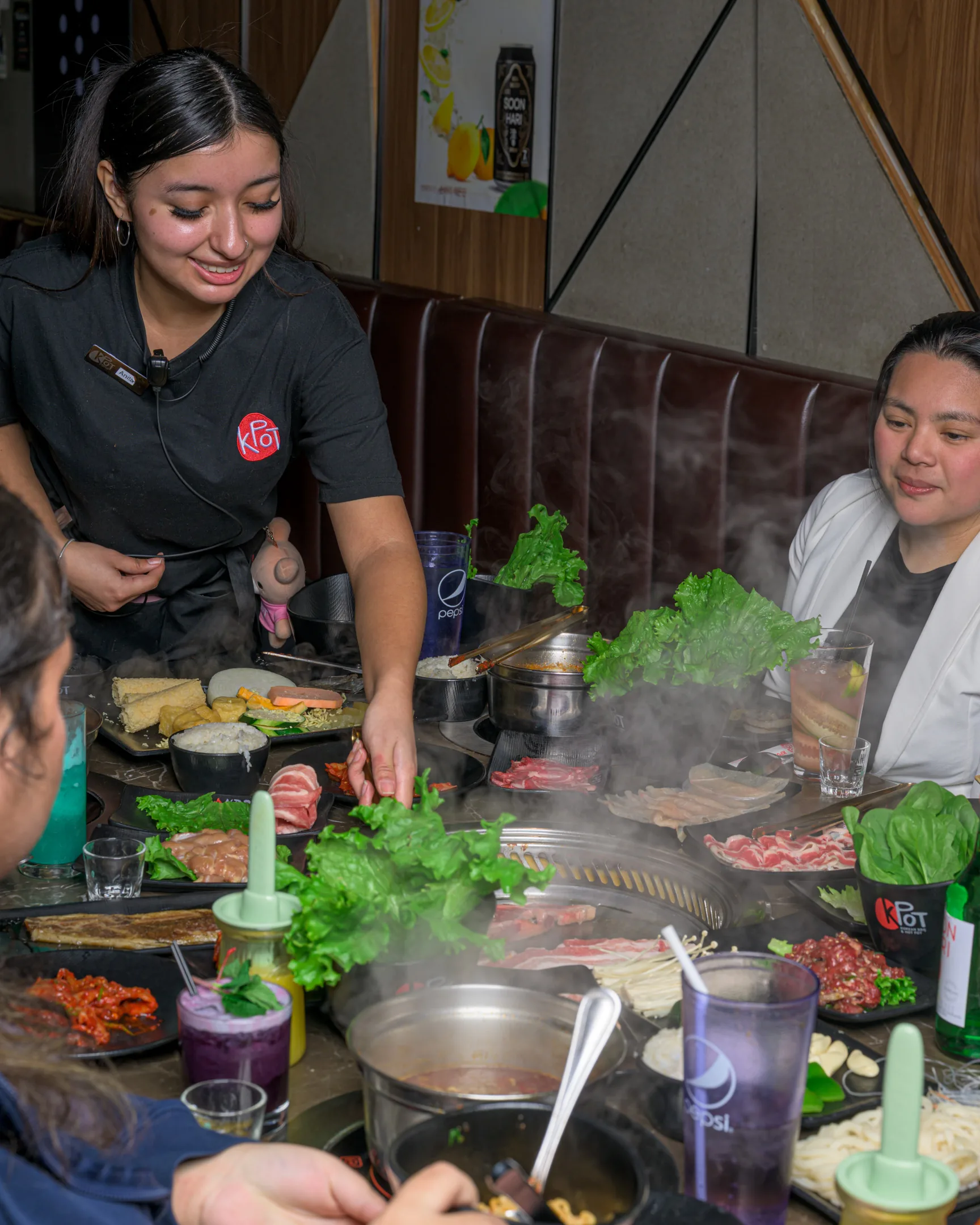 Server helping people grill at KPOT