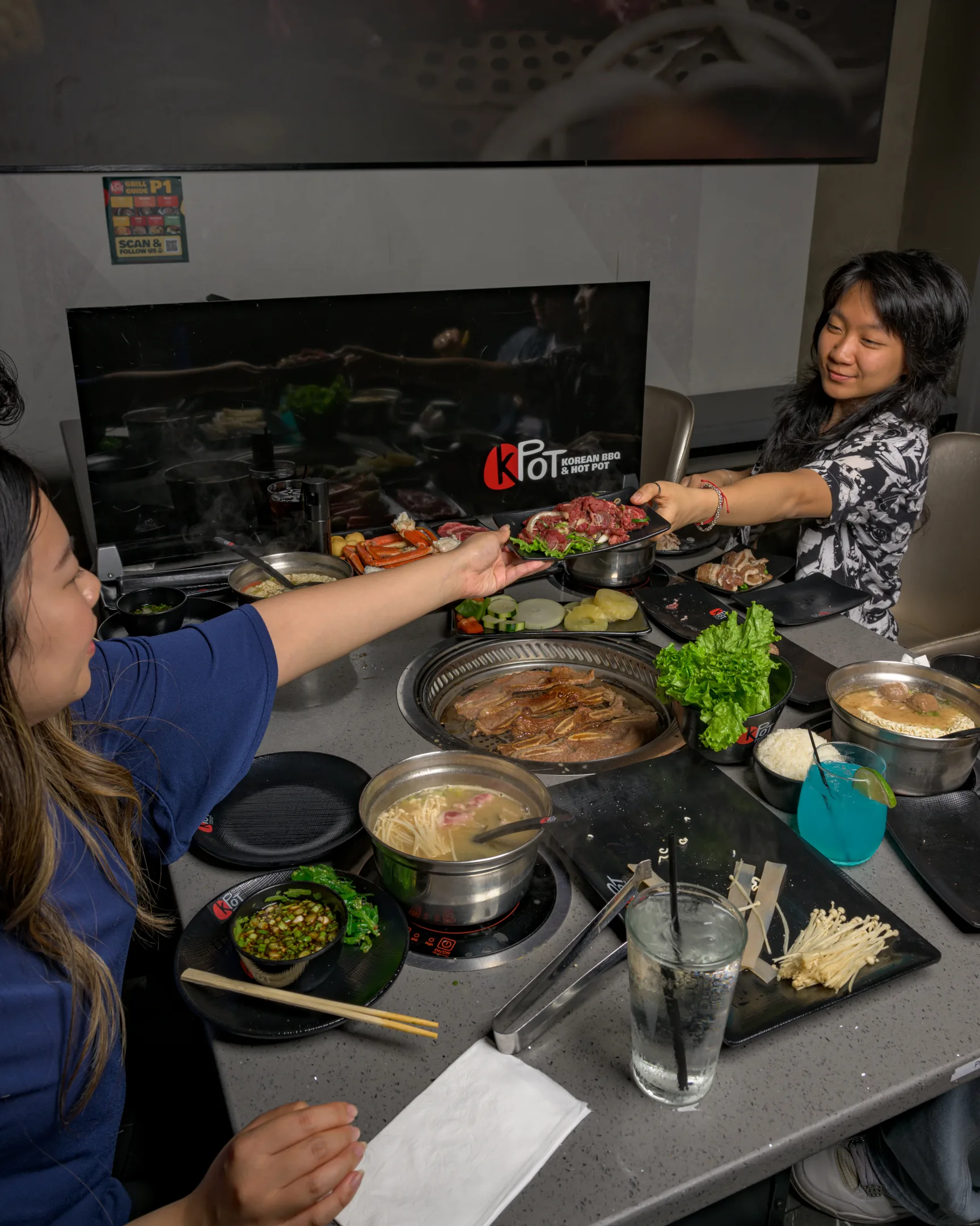 Two people sharing a grill at KPOT
